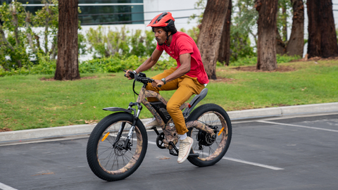 Newegg employee Jeremy Threat takes a ride on one of the company's best-selling electric bikes. (Photo: Business Wire)