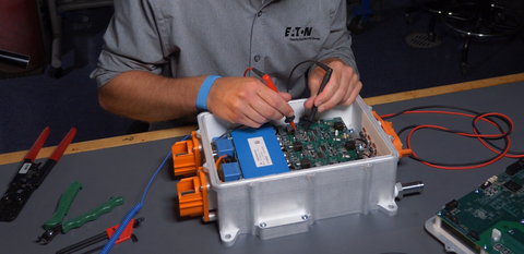 Eaton eMobility engineer inspects a high-voltage traction inverter for electric vehicles. (Photo: Business Wire)
