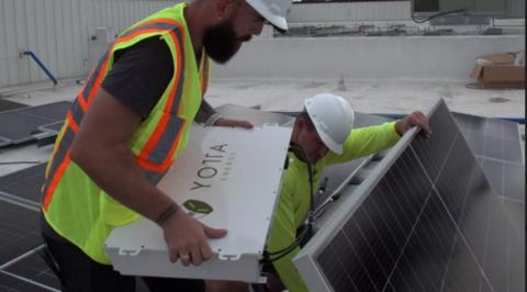 Ricky Carroll, President of EcoBuild Commercial Solar (right) and Thomas Gutierrez, Project Manager at Yotta Energy (left), installing Yotta's energy storage solution. (Photo: Business Wire)