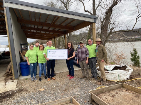 Chris Franklin, Essential Utilities CEO, presents check to Tree Pittsburgh. (Photo: Business Wire)