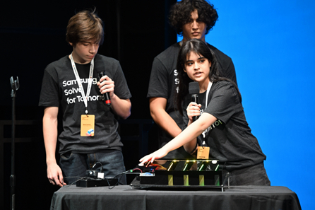 (L-R) Students River Dowdy, Johann Carranza and Lena Conde Araujo of Porter High School in Porter, Texas present their STEM project to address crowd collapse caused by an active shooter or the threat of one to judges at the Samsung Solve for Tomorrow National Finalist Pitch Event on Monday, April 25, 2022 in New York City at Samsung 837. Credit: SAMSUNG