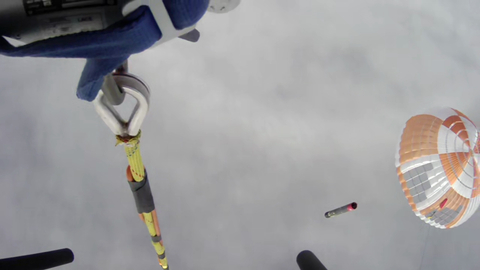 View from recovery helicopter of Electron booster returning to Earth under parachute after launch (Photo: Business Wire)