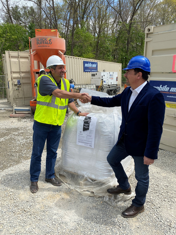 MAPEI Corporation's President and CEO, Luigi Di Geso (right) and Michael Woods, COO/CEO of Big Sun Holdings, Black Buffalo 3D’s parent corporation (left) with a super-sack of Planitop 3D. (Photo: MAPEI Corporation)