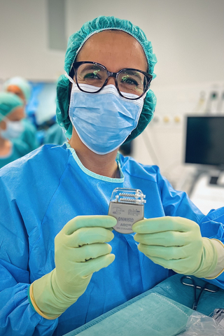 original Neurosurgeon Dr. Jocelyne Bloch holding ARC-IM IPG. Credit: ONWARD Medical