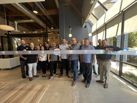 Team members from PGT Innovations, Western Window Systems, Skye Walls and their guests gather as Mike Wothe, President of Western Window Systems, cuts the ribbon at the grand opening. (Photo: Business Wire)