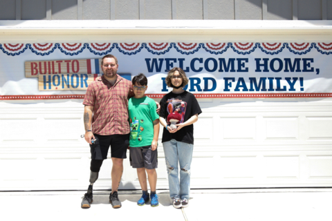 U.S. Army Sergeant James Ford and family smile in front of their new, mortgage-free home in Houston, Texas. (Photo: Business Wire)