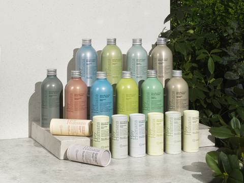 Image of Hey Humans collection in rows of deodorant, body wash and body lotion with leaves in the background (Photo: Business Wire)