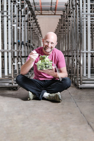 Fieldless CEO Jon Lomow enjoys a no-need-to-wash salad mix at the company's indoor farm in Cornwall, Ontario. Fieldless closed a a $17.5M Series A funding round to expand its operations. (Photo: Business Wire)