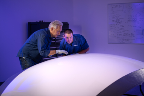 Space Perspective’s Taber MacCallum (left), Founder and Co-CEO, and Peter Tinkham (right), Manufacturing Specialist, in the testing lab, inspect a section of carbon composite exterior manufactured for Spaceship Neptune. Photo courtesy of Space Perspective.