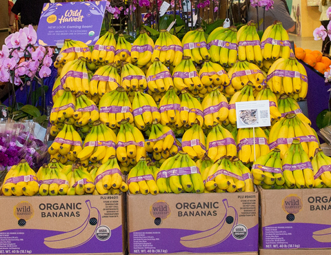 UNFI is leveraging its deep expertise to provide a broad catalog of organic produce in an easily recognized and trusted brand, Wild Harvest. Wild Harvest produce is already available in hundreds of retailers across the country and the newly launched Wild Harvest organic bananas have performed well, with dozens of additional key items will be introduced throughout the remainder of 2022. The bold purple branding makes it easier for both shoppers and store associates to recognize which products are organic, while offering the trust of the Wild Harvest label. (Photo: Business Wire)