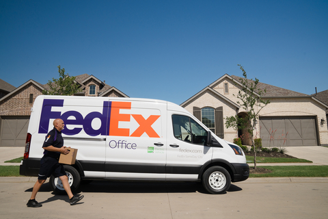 FedEx SameDay® City courier in Ford E-Transit electric delivery vehicle delivers package to customer's home. (Photo: Business Wire)