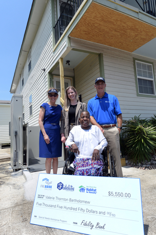 Valerie Thornton Bartholomew, seated, celebrates a new wheelchair lift installed at her home near New Orleans. She is with, from left, Jill Droge of FHLB Dallas, Chris Ferris of Fidelity Bank and Marguerite Oestreicher of New Orleans Area Habitat for Humanity. (Photo: Business Wire)