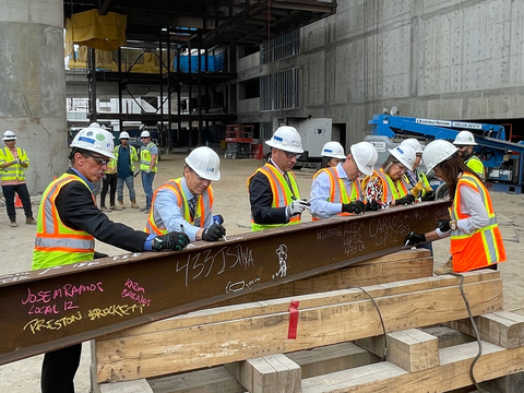 Signing the last structural station steel beam prior to it being hoisted into place. (Photo: Business Wire)