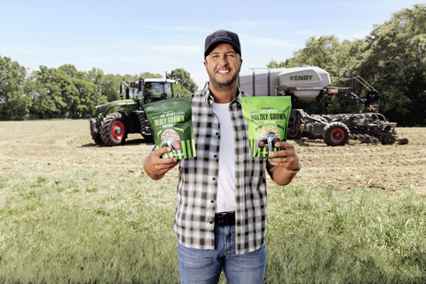 Country music superstar Luke Bryan poses with bags of Fendt & Luke Bryan’s Boldly Grown Popcorn early this summer while on his Tennessee farm. The limited supply of bags will be available for $5.00 at 12 p.m. Eastern, Thursday, Aug. 25 on BoldlyGrownGoods.com. Once supplies are sold, Fendt will donate $25,000 to Future Farmers of America. (Photo: Business Wire)