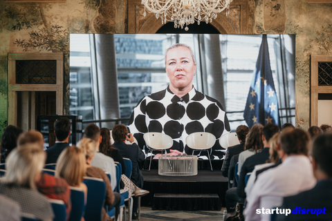 A keynote speaker delivering remarks via a telecast at the Sustainable Future Conference at the historic Martinic Palace in Prague, Czech Republic. (Photo Credit: Startup Disrupt)