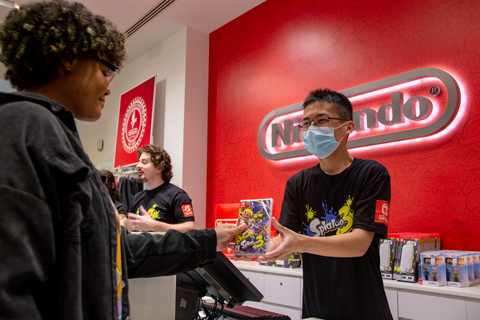 In this photo provided by Nintendo of America, Enid M. from Far Rockaway, NY is one of the first consumers to purchase the Splatoon 3 game for the Nintendo Switch family of systems during the launch event at the Nintendo NY store in Rockefeller Plaza.