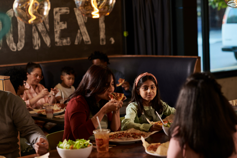 original Mother and daughter enjoying MOD Pizza. (Photo: Business Wire)