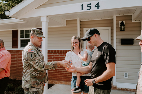 Garrison Commander, COL Robert Holcombe hands SSG Jared Wise and his family the keys to their new home at Fort Rucker. The completion of the 108 homes is part of Corvias’ larger scale initiative to advance energy savings within U.S. Army portfolio communities - an estimated $240M in future utility savings over 30 years. (Photo: Business Wire)