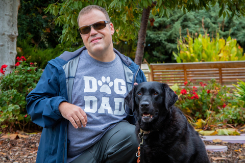AJ Milligan and Feather, his K9 Buddy (Photo: Business Wire)