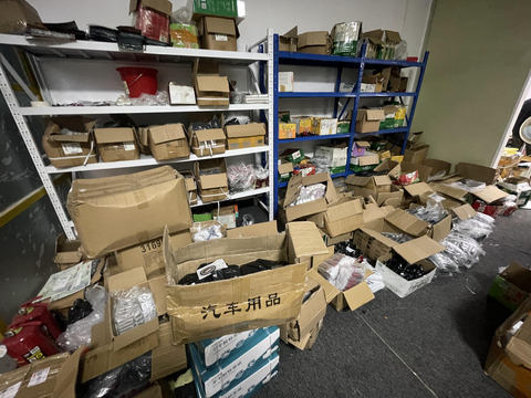 Law enforcement raid action photo of counterfeit car accessory factory (Photo: Business Wire)