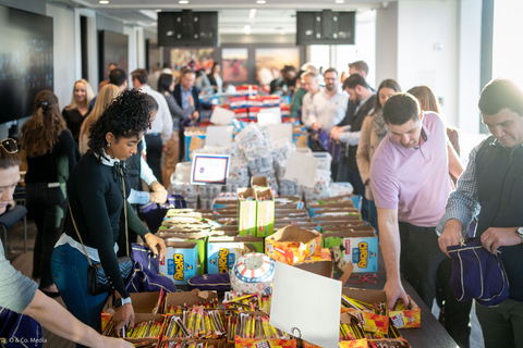 Employees come together to pack bags for our service men and women overseas (Photo: Business Wire)