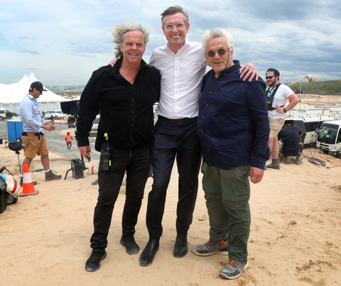 (L-R) Doug Mitchell (Producer, “Furiosa”), Dominic Perrottet (Premier of New South Wales), George Miller (Director/Producer, “Furiosa”) on the New South Wales set of “Furiosa,” an original stand-alone action adventure that will reveal the origins of the powerhouse characters from the multiple Oscar®-winning global smash, "Mad Max: Fury Road." Visual effects work for the film will be led by the new Sydney studio of industry leading VFX and animation company DNEG. (Photo: Business Wire)