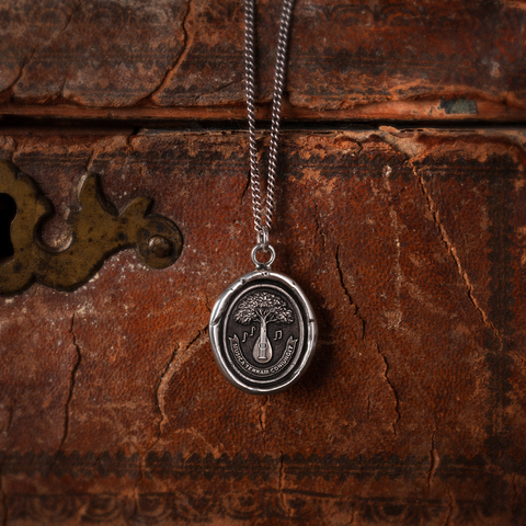 This talisman reads 'Musica Terram Coniungit' in Latin, meaning 'Music Unites the Earth.' The stringed instrument branching out into a tree is symbolic of the powerful connection between music and all living things. Pyrrha will donate full proceeds from the purchase of this talisman to support Pathway to Paris. (Photo: Business Wire)