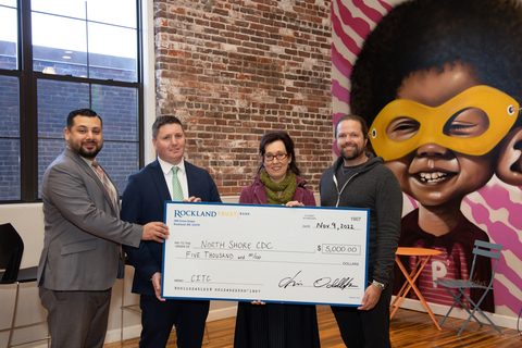 Check presentation with North Shore Community Development Coalition. Pictured left to right: Oscar Arevalo (RTC), Tom Golden (RTC), Machel Roebuck (North Shore CDC), Mickey Northcutt (North Shore CDC) (Photo: Business Wire)