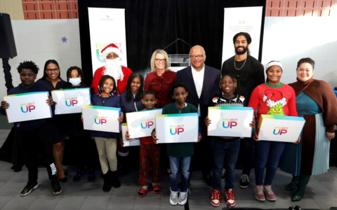 ATLANTA, GEORGIA - DECEMBER 16: Christine Whitaker, President, Central Division, Comcast, Broderick Johnson, EVP, Public Policy & Digital Equity, Comcast and students attend as Comcast celebrates the holidays with 500 laptop donation to KIPP Vision Academy on December 16, 2022 in Atlanta, Georgia. (Photo by Terence Rushin/Getty Images for Comcast)