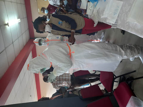 thumbnail The Infection Prevention Control Coordinator of the Ministry of Health takes AHF Uganda Cares Mentors through Ebola infection prevention control protocol. (Photo: Business Wire)