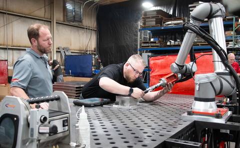 Turnkey systems for cobot welding, as seen here at sheet metal manufacturer Raymath in Ohio, is one of the solutions Universal Robots predicts will drive automation in 2023. Raymath’s CEO wrote the purchase order right after experiencing a hands-on programming demo. (Photo: Business Wire)