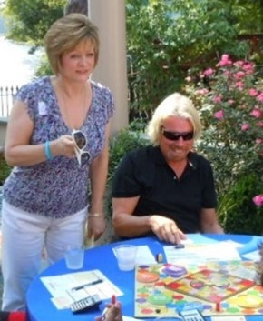 Cathy Cunningham & Richard Branson Playing IMPACT The Money Mastery Game (Photo: Business Wire)