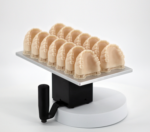 The Einstein Pro XL is the only high-volume printer qualified to 3D print Flexcera Smile Ultra+, an FDA 510(k) cleared Class II material for strong, beautiful, and permanent dental restorations, including veneers, crowns, bridges, and dentures. Monolithic dentures can be 3D printed in one piece and finished traditionally by dental technicians and artists. (Photo: Business Wire)