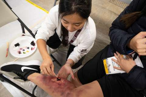 thumbnail A Texas A&M Health student applies makeup to mimic an injury--called moulage--during the Texas A&M Health Disaster Day emergency response training simulation on March 3. (Photo: Business Wire)