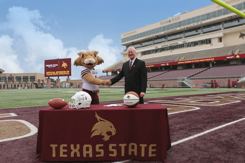 Greater Texas CEO and Texas State alumni, Howard Baker, signs multi-year sponsorship deal with Boko the Bobcat, representing Texas State Athletics. (Photo: Business Wire)
