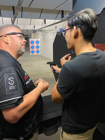 Shoot United instructor teaches student at San Antonio, TX pistol event. (Photo: Business Wire)