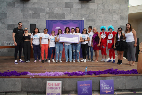 Representatives from local nonprofit Keeping Kids in School (KKIS) Project accept a grant of $12,500 from MONAT Gratitude Foundation at the More than a Race 5K in Cancun, Mexico. (Photo: Business Wire)