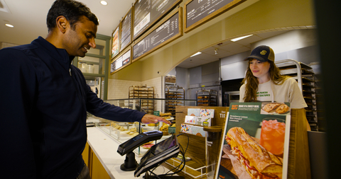 A guest using Amazon One technology at a Panera Bread café. (Photo: Business Wire)