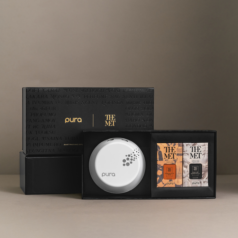 Pura and The Metropolitan collaboration set including a signature Pura Smart Fragrance Diffuser and two of The Metropolitan’s scents, Terracotta Rose and Perfume Immortelle. (Photo: Business Wire)