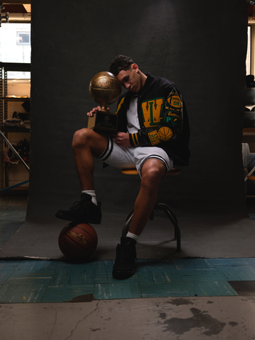 Jackson Shelstad, Oregon basketball phenom, poses in an all-black Settlemier's letterman jacket covered in custom patches. (Photo: Business Wire)