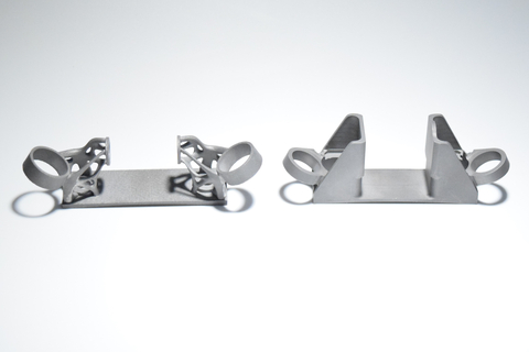 A comparison of the AM-designed bracket (left) and the traditional version (right). (Photo: Business Wire)