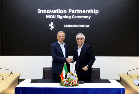 Samsung Display CEO JS Choi (right) and Ferrari CEO Benedetto Vigna (left) shake hands after a Memorandum of Understanding signing ceremony held at Samsung Display's Asan campus in Korea. (Photo: Business Wire)