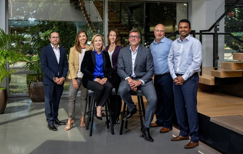 Denise Johnson and Eric Desaulniers, surrounded by members of their respective electrification leadership teams. (Photo: Business Wire)