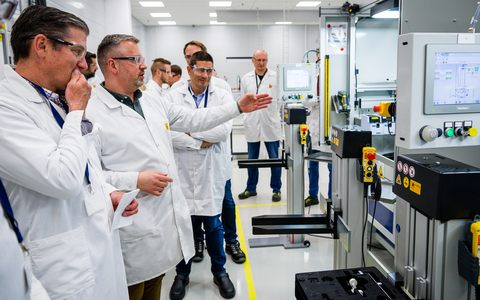 Eaton leaders, including Pete Denk, president, Vehicle Group, Eaton (left), Krzysztof Kaszkur, manufacturing manager, eMobility, Eaton (center), and Benito Dominguez, director, Operations, eMobility, Eaton (right), tour the new eMobility manufacturing line at the Vehicle Group’s Tczew, Poland, facility. (Photo: Business Wire)
