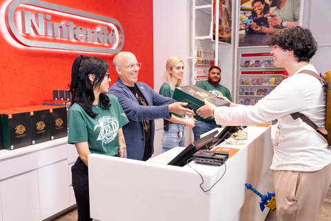 In this photo provided by Nintendo of America, Nintendo of America President Doug Bowser sells the very first copy of The Legend of Zelda: Tears of the Kingdom to an excited fan following the game’s midnight launch at the Nintendo NY store in Rockefeller Plaza. The Legend of Zelda: Tears of the Kingdom for Nintendo Switch is available now and a direct sequel to The Legend of Zelda: Breath of the Wild, where players decide their own path through the sprawling landscapes of Hyrule and discover new destinations, dangers, sights and puzzles that require wits and resourcefulness to overcome. (Photo: Business Wire)
