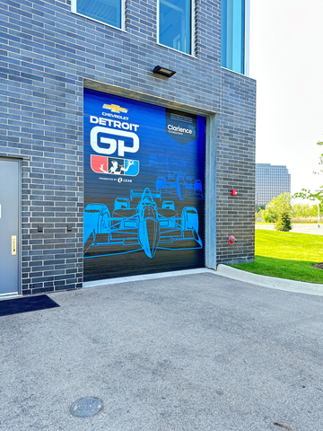 To show support of their partnership with the 2023 Chevrolet Detroit Grand Prix presented by Lear, Clarience Technologies recently installed a vinyl wrap on the exterior roll-up door to the "Innovation Bay" at their Southfield, Michigan, Global Headquarters. (Photo: Business Wire)