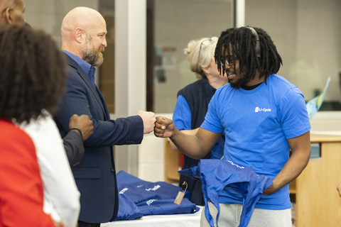 Anthony Staley (VP, Rochester Hub, Li-Cycle) hands out a laptop to a senior student at Edison Tech High School. Li-Cycle partnered with Shift2, a local non-profit, to donate laptops to 60 students at the Rochester, New York high school. (Photo: Business Wire)
