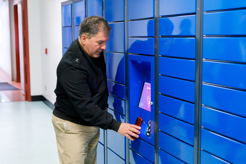 Commander, Naval Supply Systems Command (NAVSUP) Rear Adm. Peter Stamatopoulos collects mail Apr. 28 from a newly-installed smart locker installed at Naval Support Activity-Mechanicsburg, Pennsylvania. Lockers like these will give sailors around the world access to a free and secure mailbox 24/7 and removes the guess work of tracking with a fully automated system that alerts via e-mail when a package is ready for pick-up. (U.S. Navy photo by Scott Mundy. Released.)