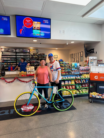 Scott Lyle, roam 'n stop CEO with neighborhood roam 'n stop customer winner of 10 speed bike giveaway. (Photo: Business Wire)