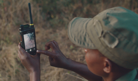 original Ranger Theressa Makunike uses a Hytera dual-mode radio to record plants in the parks (Photo: Business Wire)